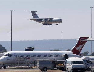 Storms ground MH370 air search after new debris sighting