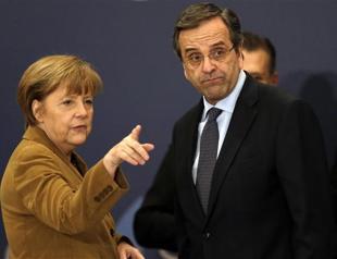 Merkel visits Athens to boost Greek government after bond sale