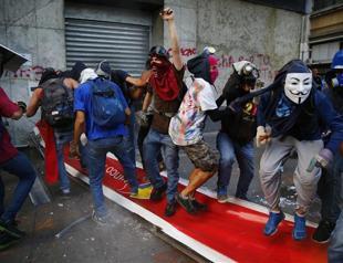 Riot police, protesters clash in Venezuela