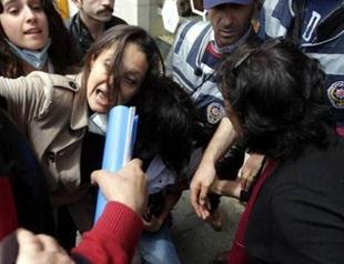 Police try to detain opposition deputy Şafak Pavey as she helps a young protester