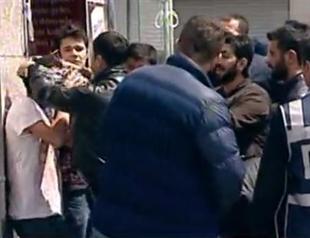 Police force young man to pose with kefiyyeh during May Day protests