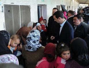 Assad visits displaced Syrians outside Damascus: TV