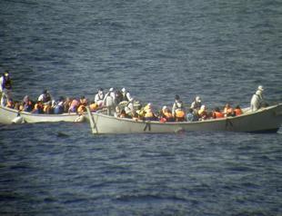 30 migrants found dead as refugee boats arrive in Italy