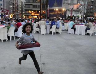 Syrian refugee children strive to get free food during iftar dinners in central Istanbul