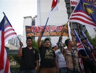 Malaysia vows MH370 transparency as families vent anger