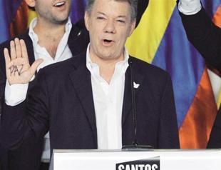 Santos re-elected in Colombia, tells FARC it’s time for peace