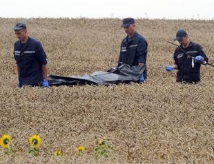 Bodies moved from MH17 site as world demands probe