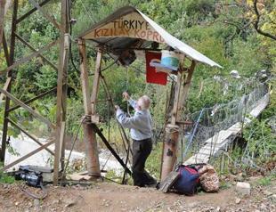 Locals draw blood to cross wooden suspension bridge in Black Sea village