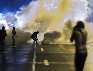 One shot, seven arrested as violence flares in riot-hit US town