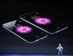 Apple reveals larger iPhones and smartwatch