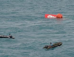 Crashed AirAsia’s tail hoisted from sea in search for boxes