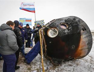 Three-man multinational space crew returns to Earth