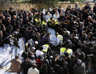 Hollande vows France will never yield as terror victims buried