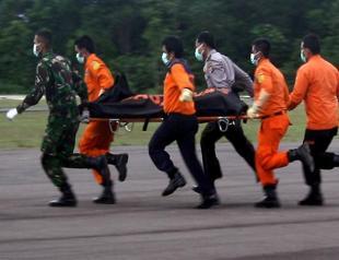 Divers find bodies belted in seats near AirAsia fuselage