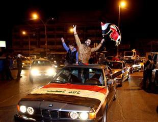 Iraqis fete curfew end with flags, horns and tyre smoke