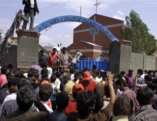 Taliban attacks on Pakistan churches kill 14, spark riots