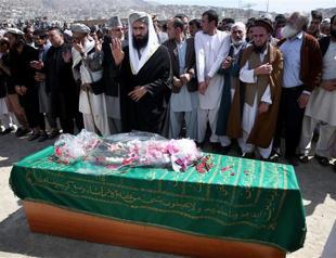 Afghans bury woman beaten to death by mob