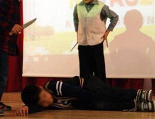 Students performing pretend animal sacrifice in play draw reaction