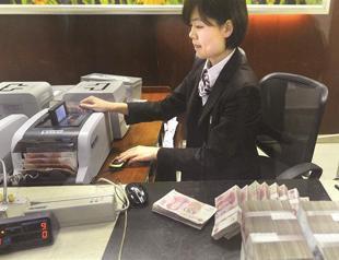 China cuts bank reserve ratio requirement as growth slows