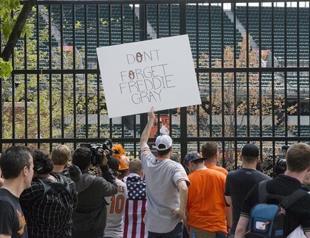 Baltimore protesters defy curfew after police officers charged