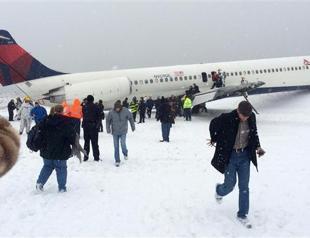 Plane skids off New York runway as winter storm hits US