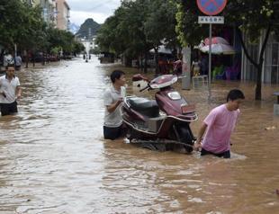 52 dead in China floods, including 2 kids on overloaded bus