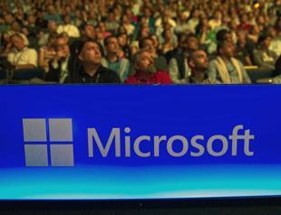 Microsoft cuts 7,800 jobs, reorganizes phone unit