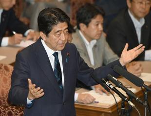 Japan PM pushes bill to expand role of military