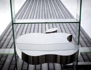 Apple profit jumps but shares slip