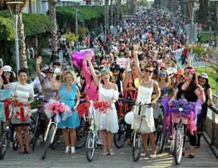 Women on Wheels: Women cyclists demonstrate with bikes, powder and paint
