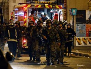 Suspect arrested over Paris attacks as raids continue across France