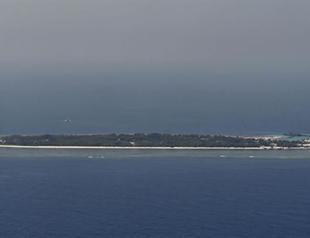 China lands first military plane on disputed reef: state media