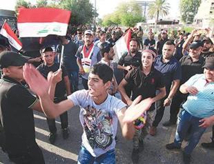 Iraqi MPs approve partial cabinet as thousands protest