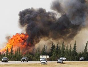 Canada fire rages for seventh day, evacuees brace for long wait