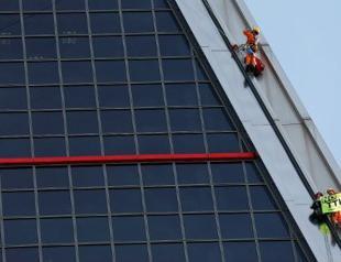 Greenpeace activists climb Madrid tower to protest US-EU trade deal