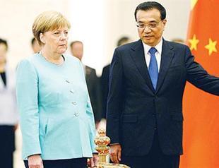 Chinese and German leaders downplay China market status tensions