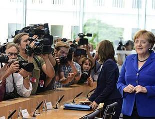 Merkel defends refugee stance after attacks