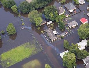 13 killed in Louisiana floods, California fires menace 82,000 people