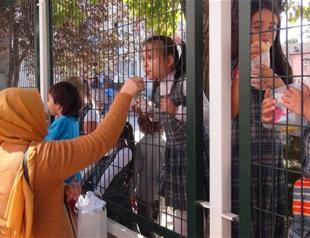 Parents feed children through fences in northwest Turkey school amid state of emergency