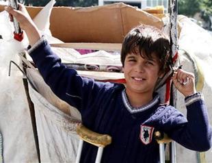 Disabled refugee child gathers paper on street in Turkey’s south for family in Syria