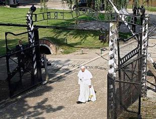 Pope Francis walks alone through horrors of Auschwitz