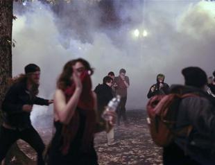 Anti-Trump protesters march amid tear gas, flash grenades