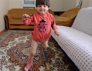 Turkish father teaching daughter with disabilities to walk with contraption due to lack of funds