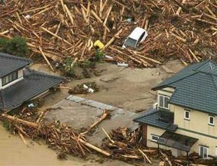 Huge floods sweep southern Japan, two dead, 18 missing