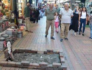 Local erects tombstone to protest removal of pavement stones in front of his shop in Turkey’s north