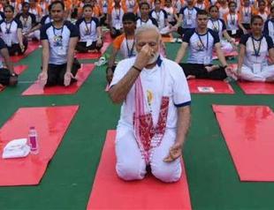 Yoga connecting world, says Modi as millions stretch and bend