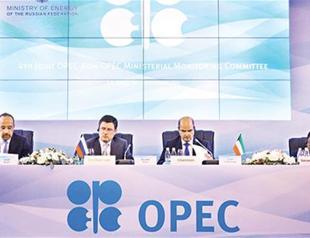 Saudi calls OPEC members to stick to limits, sees oil demand up