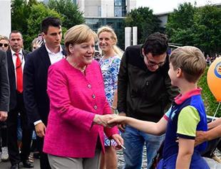 Merkel has no regrets over refugee policy despite political cost