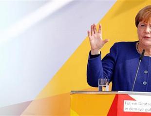 Merkel vows to restrict trade with Turkey over arrests