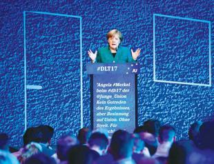 Merkel settles row on migrant quotas